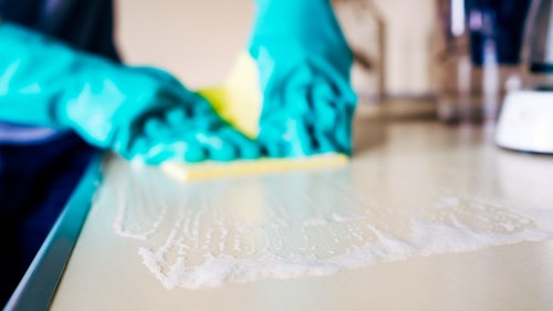 Technician performing oven cleaning at Jack Cleaners